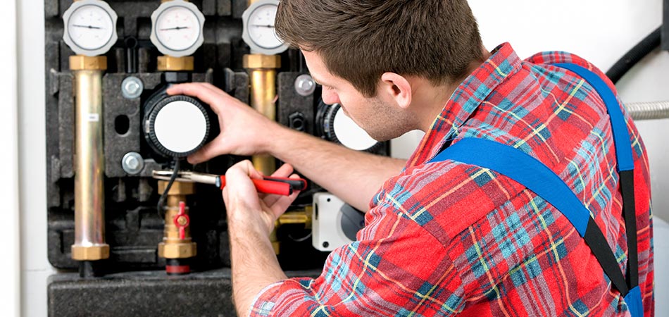 A technician repairing a furnace